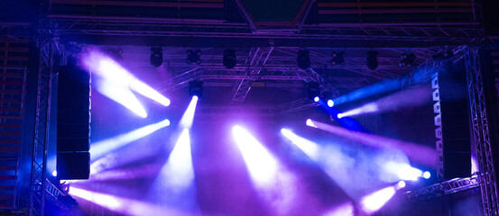 Spot lights on the stage during night concert in summer