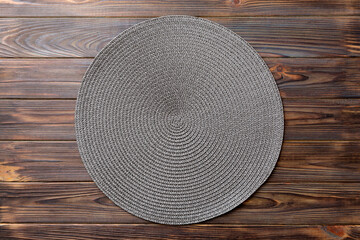 Fototapeta na wymiar Topview of round tablecloth for food on wooden background. Empty space for your design