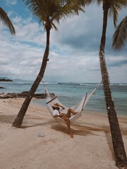 Girl relaxing on the beach in a hammock