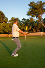 Obraz premium Golfer male ready to be struck the ball on green grass on golf course.