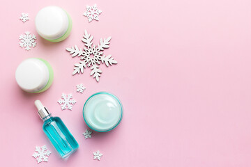 Makeup products and Christmas decorations on color background. Top view New year Beauty concept with copy space