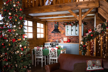 Kitchen is decorated with Christmas garlands and Christmas tree in halet