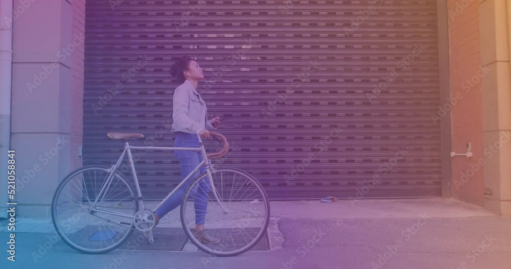 Sticker Spots of light against asian woman using smartphone while walking with her bicycle on the street