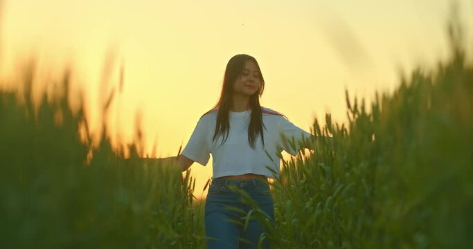 japanese girl is walking in beautiful rye field in sunset, enjoying nature, portrait, 4K, Prores
