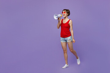 Full body young fun woman 20s she wear red tank shirt eyeglasses hold scream in megaphone announces...