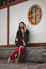 Portrait of sexy and young japanese girl with beautiful old traditional red kimono and black yukata...
