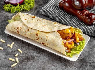 Cheesy Chicken shawarma Wrap served in a cutting board on grey background side view of fastfood
