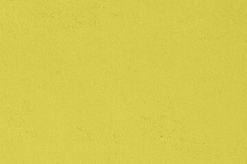 Saturated pastel yellow colored low contrast Concrete textured background. Empty colourful wall texture with copy space for text overlay and mockups. 2023, 2024 color trend