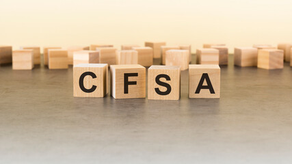 four wooden blocks with the letters cfsa - on the surface table.