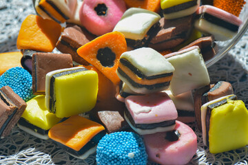 Licorice Allsorts spilling out onto a surface, haphazardly arranged as they fell
