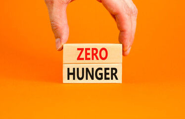 Zero hunger symbol. Concept words Zero hunger on wooden blocks on a beautiful orange table orange...