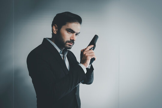 gunman with gun. portrait of serious and attractive hitman or special agent man holding gun. Businessman holding a gun. handgun, assassin.  gangster.