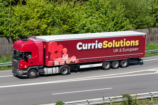 WIEHL, GERMANY - MAY 3, 2022: Scania truck with Currie Solutions curtainside trailer on motorway