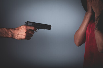 man holds a gun in his hands and threatens girl