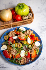 nicoise salad with tuna on the table with vegetables top view