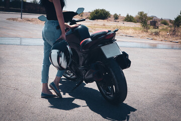 slim sexy girl posing by motorcycle