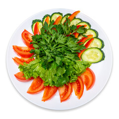 Sliced tomatoes, cucumbers, red pepper and garnished with parsley and lettuce. Fresh Vegetables Plate. Isolate