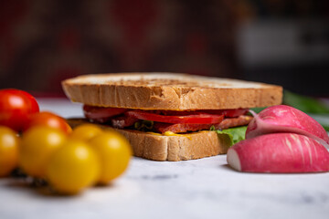sandwich of bread toasts and vegetables on a wooden board