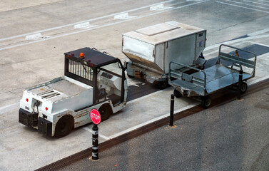 Car and trolleys for transporting suitcases at the airport.