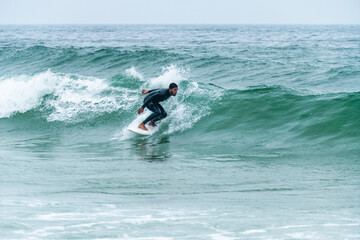Surfer riding a wave © homydesign