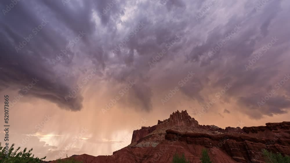Canvas Prints monsoon rainstorm moving through capitol reef at sunset with flashes of lightning.