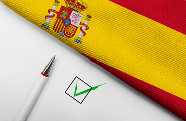 Pencil, Flag of Spain and check mark on paper sheet
