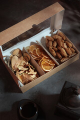 Fruit chips and apple pastille in a box made of craft cardboard. Environmentally friendly packaging. A useful product for a light snack. The box is open. Top view.