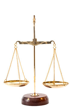 Gold balance scales with metallic chains and wood base used to compare weights, isolated on white background with clipping path cutout concept for legal judgment, justice metaphor and equality law