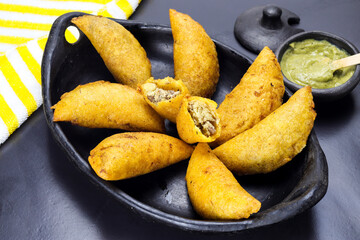 corn empanada typical Colombian food with spicy sauce
