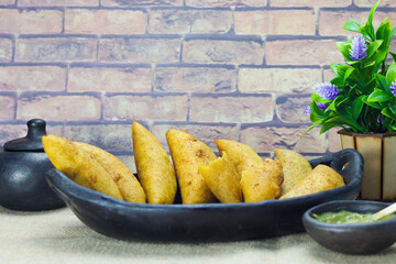 corn empanada typical Colombian food with spicy sauce