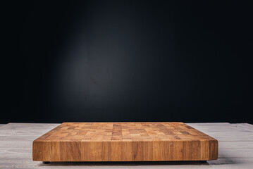 Wooden cutting board on black background