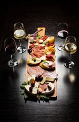 Wine and charcuterie and cheese board with a place for text. Prosciutto di Parma ham, blue cheese....