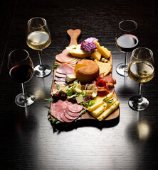 Wine and charcuterie and cheese board with a place for text. Prosciutto di Parma ham, blue cheese....