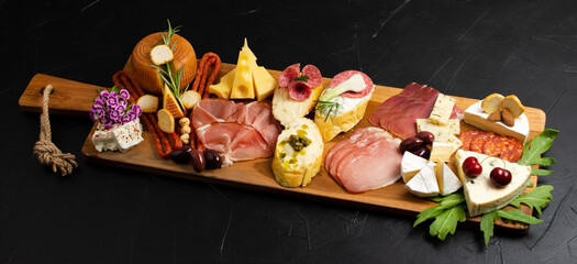 Appetizers table with differents antipasti, charcuterie, snacks and cheese. Buffet party. Top view, copy space