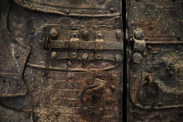 old iron-clad wooden door in medieval castle background