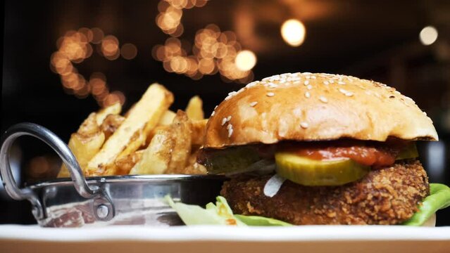 A vegan burger with chips is displayed in a fancy pub
