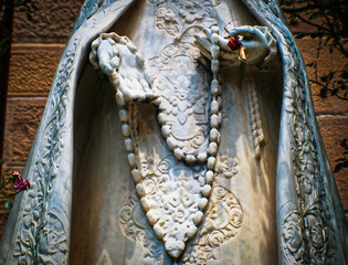 2017_07_19_Santa Fe USA - closeup of marble statue of mary with elegant robe and rosary beads....