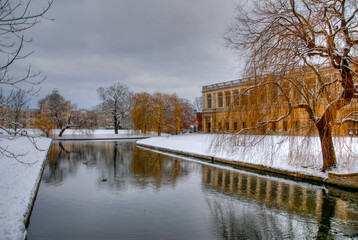 Winter in Cambridge with snow on banks of the University of Cambridge. Gloomy winters day.