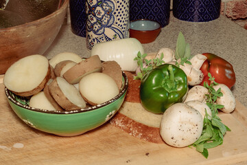 Steaming Potatoes, vegetables on a cutting board