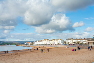 Fototapeta na wymiar Exmouth, Devon/UK- February 17 2018: Holidaymakers enjoy a chilly winter day outdoors at Exmouth beach sea front