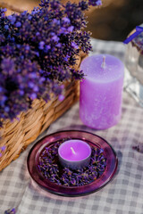 Naklejka na ściany i meble Basket with beautiful lavender in the field in Provance with Lavander water and candles. Harvesting season