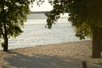 Summer calm minutes on the bank of the Dnieper after an air raid spring trees