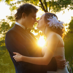 beautiful bride and groom in the nature at sunset