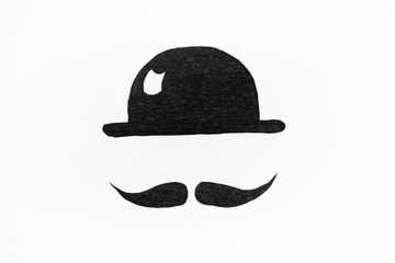 Naklejka premium Photo of a drawing of a black hat and mustache