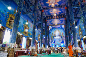 Fototapeta na wymiar The white principal chapel in Rong Suae Ten temple at Chiang Rai province. Beautiful blue temple in Thailand.