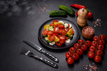 Fresh, delicious salad with cherry tomatoes, cucumbers, sweet peppers, cheese and olive oil