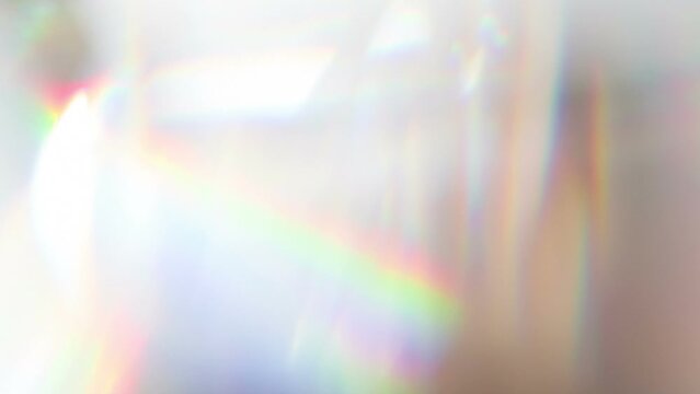 Slow Play Rainbow Crystal. Loop. The light passes through the facets of a slowly rotating diamond and creates repetitive sparkling highlights and rainbow colors