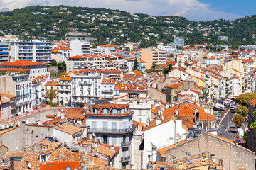 Residential houses with red roofs are under cloudy sky. Cannes