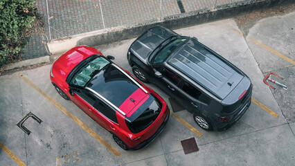 Red and black cars is parking near office building or store top view