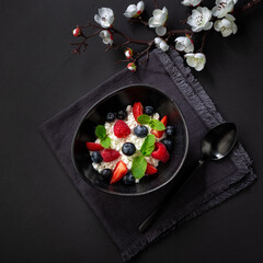 Cottage cheese with raspberry and blueberry, fresh berries, healthy breakfast concept, top view